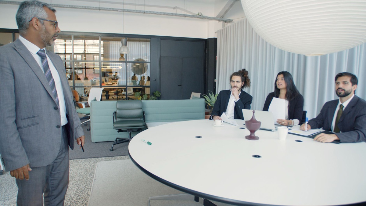 K-artist with global team in meeting room
