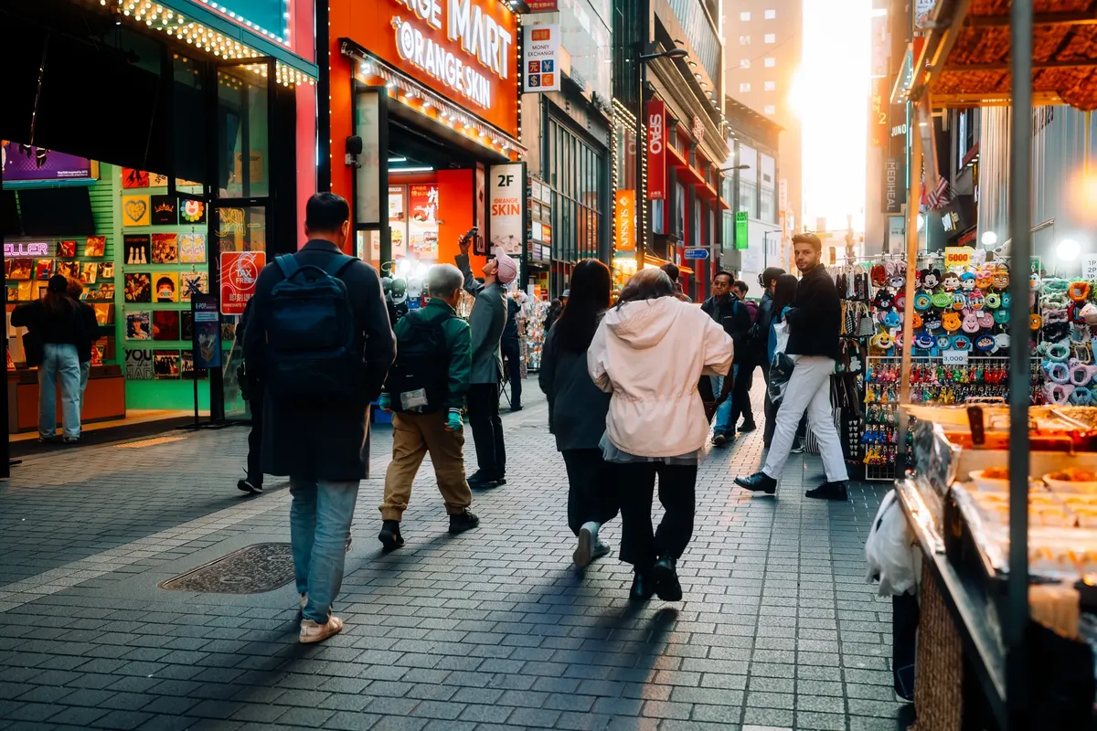 ソウルのにぎわいの通り市場を探索し、色とり丰富的なスタンドと多様な人々が満たされている。