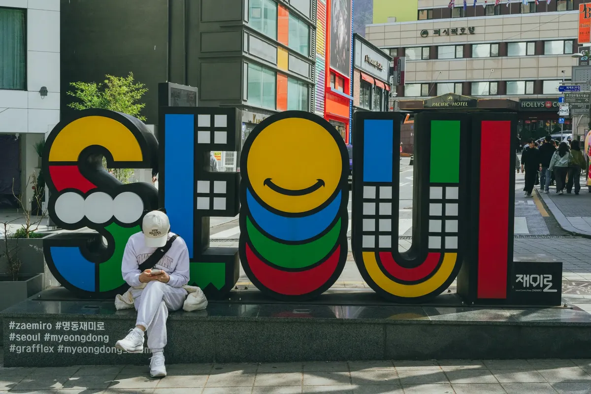 A vibrant Seoul sign in Myeongdong, South Korea, capturing the bustling street vibe.